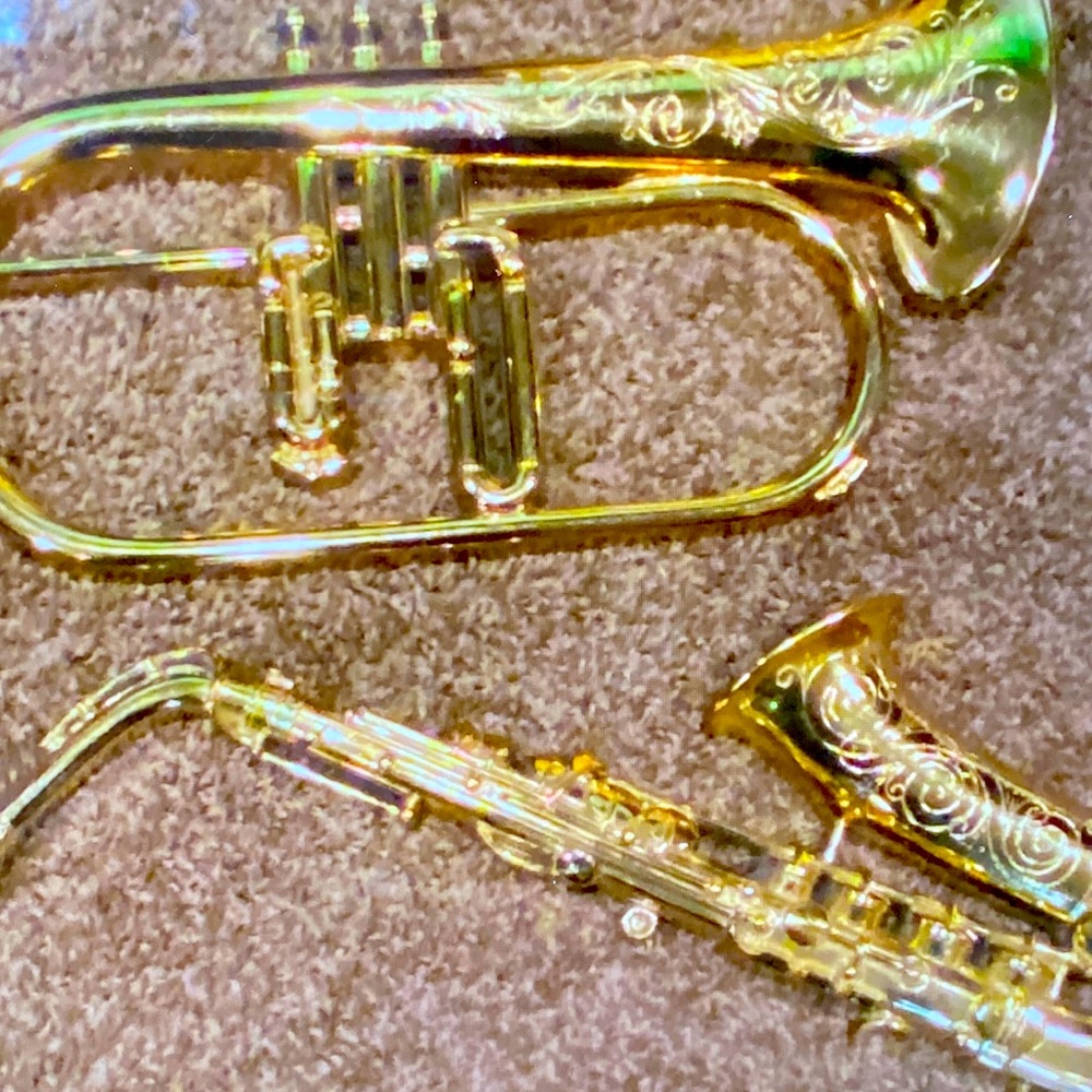 Gently used, wall decor plastic flugelhorn and saxophone.